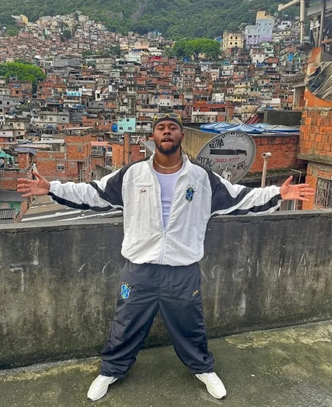 A person standing on a rooftop with a city in the background
AI-generated content may be incorrect.